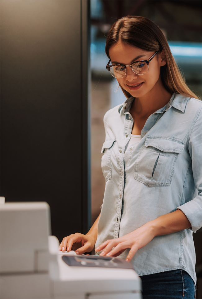 woman standing in front of a multifunction printer