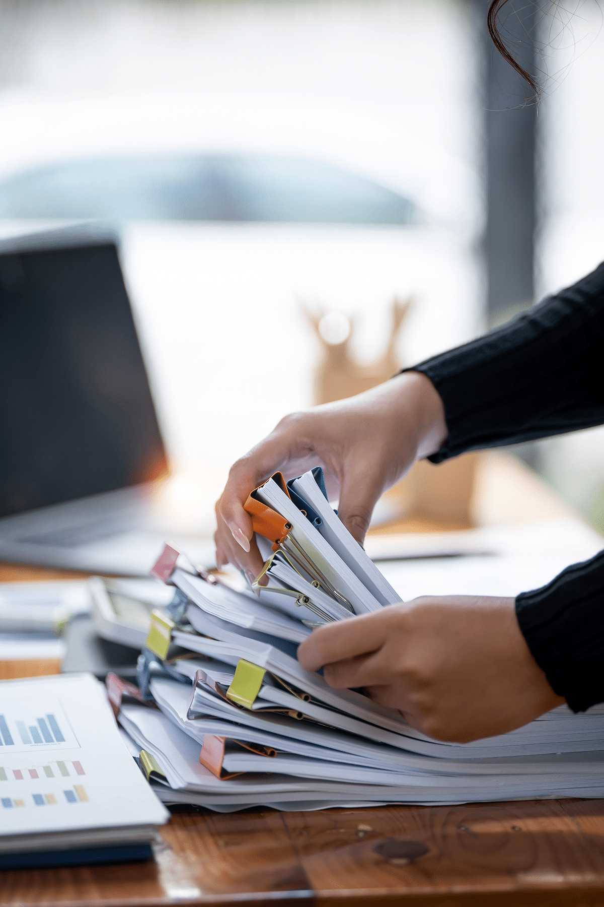 hand sorting through a stack of documents